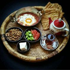 there is a tray with food on it that includes bread, crackers and an egg