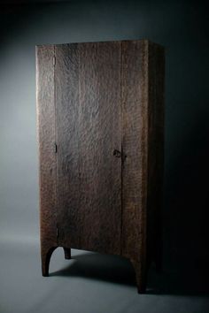 a tall wooden cabinet with two doors on one side and an open door on the other