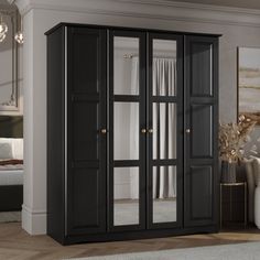 a black armoire with mirrored doors in a living room