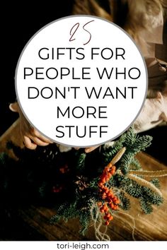 a person holding a christmas tree with the words gifts for people who don't want more stuff