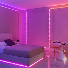 a bedroom with purple lighting and a bed in the middle is lit up by pink lights