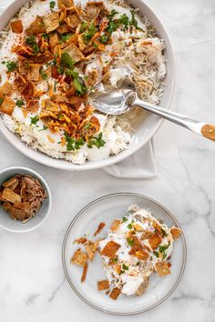 a bowl filled with rice, meat and veggies on top of a table