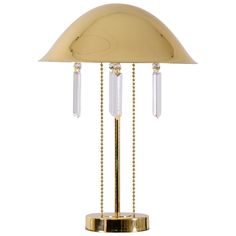 a gold colored table lamp with glass beads