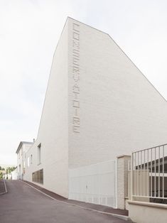 a large white building sitting on the side of a road