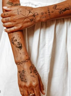 a woman's arm with tattoos on it