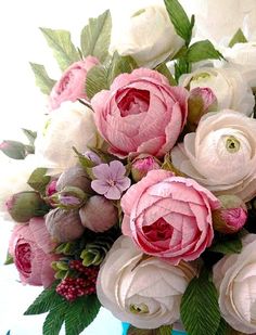 a vase filled with lots of pink and white flowers