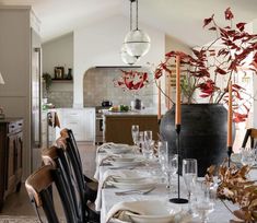 a dining room table set with place settings