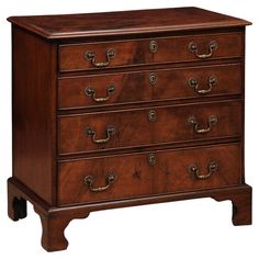 a wooden dresser with many drawers and knobs on the top drawer, all in dark wood