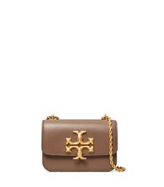 Directly from Tory Burch - Signature hardware, scaled-up in sculptural brass. The Eleanor Small Bag is a structured shape in soft Italian leather - with edges that are painted by hand, to emphasize the clean lines. Its twisted rope chain is convertible: wear it doubled or long and crossbody. Tory Burch Official Site. Gold Leather Bag With Logo, Gold Crossbody Bag With Logo, Gold Logo Crossbody Bag, Designer Tan Crossbody Bag, Luxury Tan Shoulder Bag With Logo, Designer Tan Shoulder Bag With Logo, Tan Leather Bag With Logo, Evening Bag With Logo In Tan, Tan Evening Bag With Logo