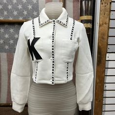 a mannequin wearing a white jacket with an arrow on it