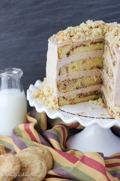 a cake that has been cut in half and is sitting on a plate next to some cookies