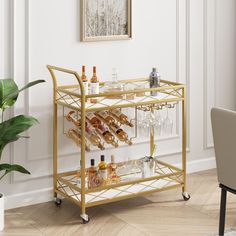 a gold bar cart filled with bottles and glasses