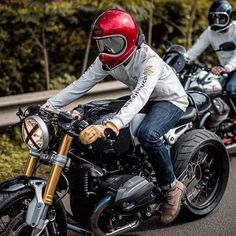 two people riding on the back of motorcycles