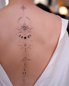 the back of a woman's neck with an intricate design on her left side