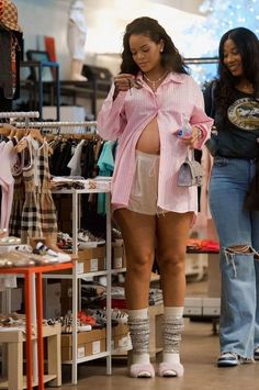 two women looking at items in a clothing store