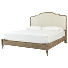 the headboard and foot board of a bed with white linens on top of it