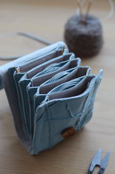 several folded blue cloths sitting on top of a wooden table