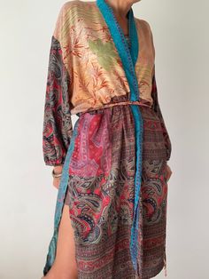 "This is one of a kind patchwork, upcycled silk robe Made free size with wrap tie closing and short sleeves  Easy and fun to wear around the house or outside as a urban boho style,  flowy kardigan with jeans and tshirt  It is very comfy and feels soft and light  the material is colourful indian saree silk made into this unique stylish over all MEAESURE free size length 38\" MATERIAL *saree silk, no lining More ideas at  https://www.etsy.com/shop/AltheaStores? CARE INSTRUCTIONS  * Wash in warm wa Bohemian Kimono With Tie Waist And Kimono Sleeves, Bohemian Silk Wrap Dress, Patchwork Long Sleeve Kimono For The Beach, Long Sleeve Patchwork Kimono For The Beach, Bohemian Kaftan With Tie Waist And Kimono Sleeves, Beach Kimono With Patchwork Sleeves, Bohemian Long Sleeve Patchwork Kimono, Bohemian Long Patchwork Kimono, Bohemian Long Kimono With Tie Waist