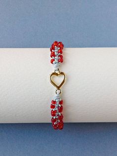 Red Seed Bead Heart Bracelet, Valentines Day Bracelet, Tiny Macrame Bracelet, Gift For Her The Bracelet is made by me with seed beads in red color, gold tone metal heart and light grey synthetic satin cord. ❥It is perfect as a gift to a friend or someone you love. SIZES: --------- Metal heart: 15 mm x 9 mm Width of Bracelet: 6 mm Synthetic Satin Cord: 0.9 mm Seed Beads: 2 mm Adjustable size in length with a sliding spiral macrame knot. Expands from 15 to 26 cm. Let me know if you need a differen Red Heart Beads Bracelet For Valentine's Day, Gift Red Beaded Heart Bracelet, Adjustable Red Heart Bead Bracelet, Valentine's Day Red Beaded Heart Bracelet, Red Heart-shaped Bracelets For Valentine's Day, Macrame Knot, Metal Heart, Macrame Bracelets, Heart Bracelet