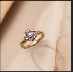 a diamond ring sitting on top of a table