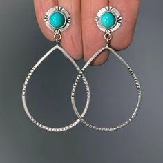 "These made-to-order turquoise hoop earrings are created from hand forged sterling silver and 8mm round turquoise stones. The hoops are teardrop shaped and stamped to reflect their shape. There are more hand stamped details around the turquoise stones. Having the stone set as a post at the top makes them feather light while still giving you a larger hoop to play with.  The earrings in the pictures have sold and are pictured so you can see the earring design (and size). Also available in a bright satin finish (the patterns will still be dark). The bright finish is shown in the next to last picture. Made-to-order with turquoise stones of your choice (see the last picture) - just select from the menu. There's a wonderful variety of turquoise to choose from: blues, greens, and teals. Details: Turquoise Teardrop Hoop Earrings Nickel Free, Teardrop Turquoise Nickel-free Hoop Earrings, Turquoise Teardrop Nickel-free Hoop Earrings, Nickel-free Teardrop Turquoise Hoop Earrings, Nickel-free Turquoise Teardrop Hoop Earrings, Turquoise Teardrop Sterling Silver Hoop Earrings, Teardrop Hoop Earrings, Oxidized Silver Rings, Turquoise Hoop Earrings