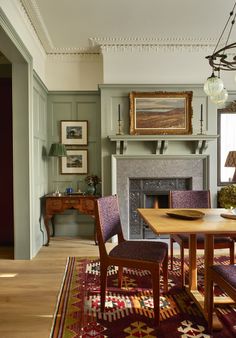 a dining room table with chairs and a fire place in the corner near a fireplace