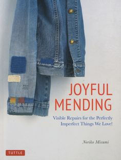 a jacket hanging on a wall with the title joyful mending visible