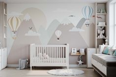 a baby's room decorated in pastel colors with hot air balloons on the wall