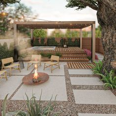 an outdoor fire pit surrounded by wooden benches and tables with chairs around it, next to a tree