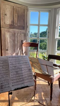 an open book sitting on top of a wooden table in front of a piano keyboard