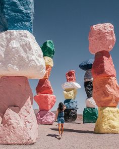 a woman standing in front of colorful rocks