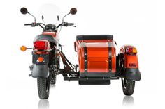 an orange motorcycle with a side car attached to it