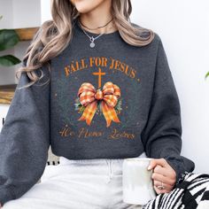 Fall for Jesus he never leaves coquette sweatshirt.  This is a wonderful gift for the special believer in your that loves Jesus and the fall season. Trendy coquette vibe.  Great gift for mom, sister, aunt, grandma, friend, pastors wife, bible study women.  Crewneck is unisex and cozy. At ATTA TOOD, we offer a wide range of tees - from faith-based to family, funny, holiday, and beyond. Our faith is the foundation of our shop, but let's be real... we love to sprinkle in a little sass too!  ATTA TO Long Sleeve Sweatshirt For Fall Gift, Crew Neck Sweater For Fall - Great As Gift, Crew Neck Sweater As Fall Gift, Fall Graphic Print Sweater Gift, Fall Graphic Print Sweater As A Gift, Cotton Sweater For Fall, Perfect As A Gift, Cotton Sweater As Fall Gift, Fall Letter Print Sweatshirt Gift, Fall Letter Print Sweatshirt For Gift