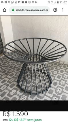 a round metal table sitting on top of a tiled floor