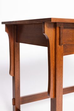 a wooden desk with two drawers and one drawer on the bottom shelf, against a white background