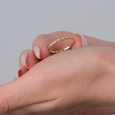 This gorgeous, delicate 14-carat gold ring features a beaded rope band. Its simple and elegant design makes it the perfect everyday piece or thoughtful gift for someone special.  RING DETAILS ♥ Gold Material: 14K Solid Gold ♥ Design: Beaded twisted band  ♥ Gold Color Options: Choose from 14K yellow gold, 14K white gold, or 14K rose gold ♥ Craftsmanship: 100% Handmade and made to order ♥ Versatility: Perfect for daily wear or special occasions ♥ 100 % Handmade ♥ Made to Order ♥ Choose Your Ring Size: (Sizes available upon request) PROCESSING & SHIPPING We know you're excited to get your hands on your order, and we're just as excited to get it in your hands. We really care about each order and do our best to process and ship your new piece as quickly as we can. ♥ Processing time: 1-5 busines Delicate 14k Yellow Gold Bands, Minimalist Yellow Gold Band Jewelry, Minimalist Yellow Gold Jewelry With Decorative Band, Delicate Yellow Gold Stackable Bands, Delicate Stackable Yellow Gold Bands, Dainty Adjustable Half Eternity Jewelry, Adjustable 14k Gold Stackable Rings With Diamond Cut, Adjustable Yellow Gold Stackable Rings With Diamond Cut, Adjustable 14k Gold Diamond-cut Stackable Rings