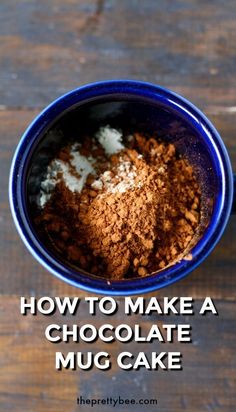 how to make a chocolate mug cake with cocoa powder and sugar in the middle, on top of a wooden table