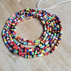 This colorful waistbead was made with multicolored glass seed beads.Waistbead length: 50 inches Strung on strong, cotton cord with 2 clear anchor beads (for adjustment) and 2 knots. Tie on, permanent waistbeads. Waist beads have been worn for centuries in African tradition, and the uses are endless. From adornment and weight management, all the way to signs of maturity and femininity, the diversity of waist beads make them appealing pieces of jewelry to own. They are generally worn under a garme Multicolor Waist Beads For The Beach, Multicolor Waist Beads For Beach, Multicolor Round Waist Beads For Beach, Multicolor Beaded Waist Beads For Summer, Adjustable Multicolor Waist Beads For Summer, Multicolor Waist Beads For Summer Festival, Colorful Waist Beads For Festivals, Colorful Waist Beads For Summer, Adjustable Multicolor Waist Beads With Large Beads