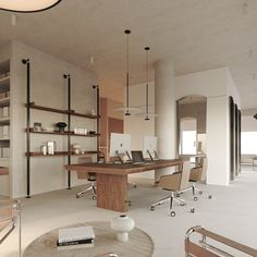 an office with two desks and chairs in the middle of it, surrounded by open shelving