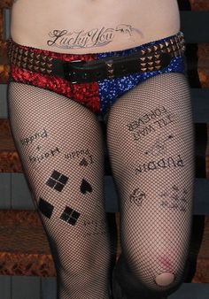 a woman wearing fishnet stockings with writing on them