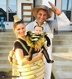 a man and woman in costumes holding a baby