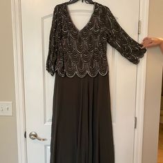 Originally $200 And Never Worn! Dark Grey Chiffon Dress, Fully Lined, Zipper Back Entry. Bodice Features Scalloped Beading And Sequence. V-Neck Front And Back Neckline. Floor Length. Sequin V-neck Evening Dress For Mother Of The Bride, Formal Beaded V-neck Evening Dress, Sequined Chiffon V-neck Dress, Sequin V-neck Chiffon Dress, Embellished V-neck Evening Dress For Mother Of The Bride, Embellished V-neck Mother Of The Bride Dress For Evening, Embellished V-neck Mother Of The Bride Dress For Party, Embellished V-neck Mother Of The Bride Evening Dress, Formal V-neck Mother Of The Bride Dress With Sequins