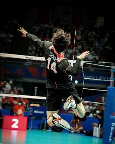 a man jumping in the air while playing volleyball