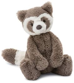 a stuffed raccoon is sitting on the floor