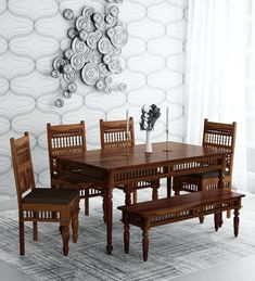 a dining room table and chairs with a bench in front of the wall decorated with circles