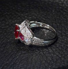 A stunning art deco ruby and diamond replica ring set with cubic zirconia gemstones in platinum overlay sterling silver. US size 7. Only your jeweler will know this is not a fabulous antique art deco ruby ring. *Fine jewelry authenticated by a GIA Gemologist *FREE SHIPPING in USA with signature required for your protection * RETURNS: Contact me for instructions within 7 days - PLEASE NOTE: Returns cannot be accepted on items which have been altered or resized. NO RETURNS ON ITEMS WHERE THE SHOP Classic Jewelry With Diamond Accents And Lab-created Ruby, Red Cubic Zirconia Jewelry With Accent Stones, Lab-created Ruby Promise Ring With Diamond Accents, Dazzling Formal Rings For Valentine's Day, Classic Cubic Zirconia Ruby Ring, Luxury Ruby Ring With Cubic Zirconia Center Stone, Dazzling Red Diamond Ring With Diamond Accents, Art Deco Ruby Jewelry With Brilliant Cut, Dazzling Red Ruby Ring With Diamond Accents