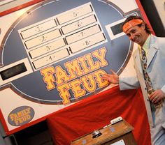 a man standing in front of a family feup sign with his hands out to the side