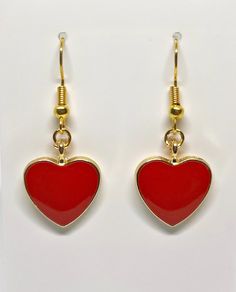 Beautiful red heart shaped earrings perfect for any occasion. Trendy Heart-shaped Earrings For Gifts, Red Drop Earrings For Valentine's Day, Trendy Heart Shaped Earrings For Gifts, Heart-shaped Jewelry With Heart Graphic For Valentine's Day, Valentine's Day Heart Detail Earrings, Elegant Red Double Heart Earrings, Red Heart Pendant Earrings, Red Heart Print Earrings For Gifts, Trendy Heart-shaped Earrings With Heart Charm