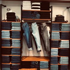 a closet filled with lots of different types of jeans