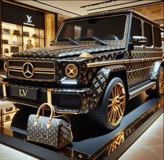 a black and gold mercedes g - class vehicle on display in a store window with handbags